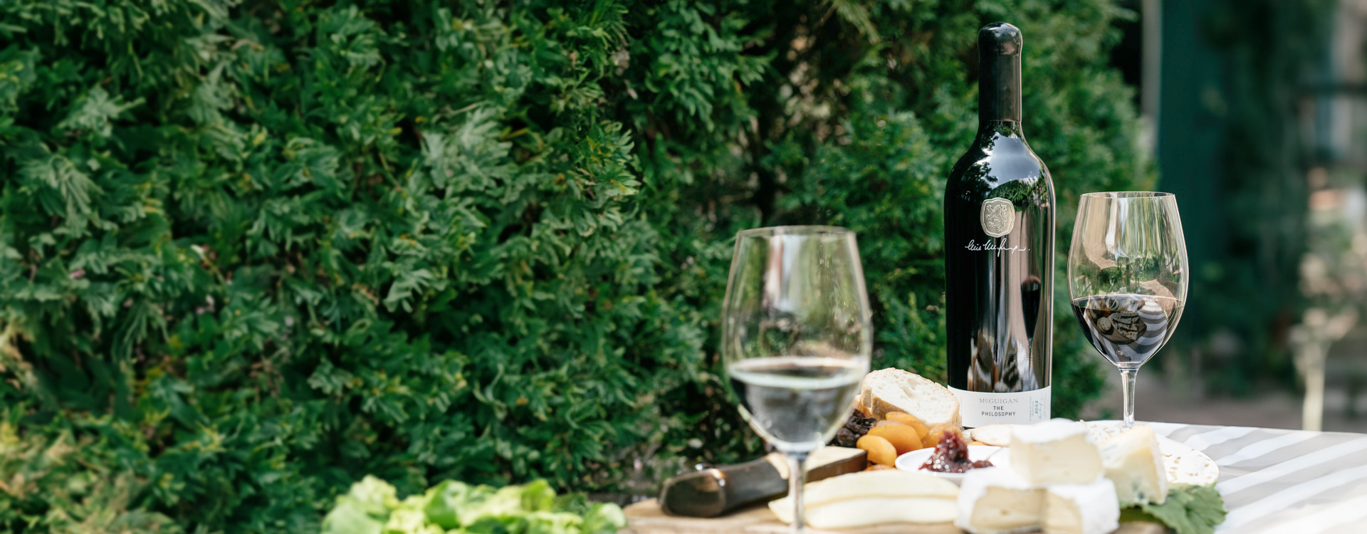 McGuigan Cellar Select Moscato bottle with bread and assorted salads